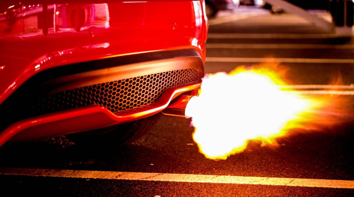 A red car with automobile exhaust system showcasing high car performance