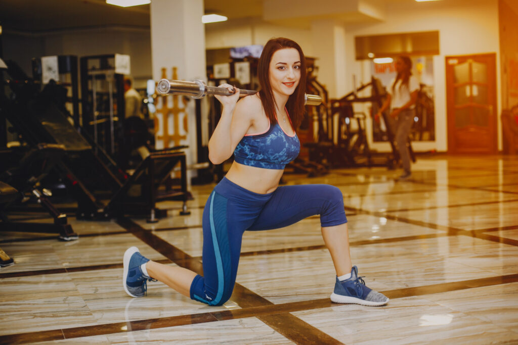 a girl workinout with gym equipmen in a gym