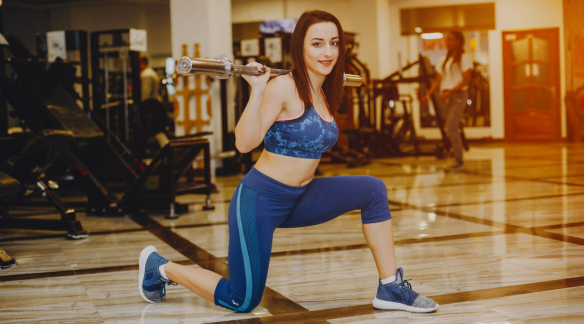 a girl workinout with gym equipmen in a gym