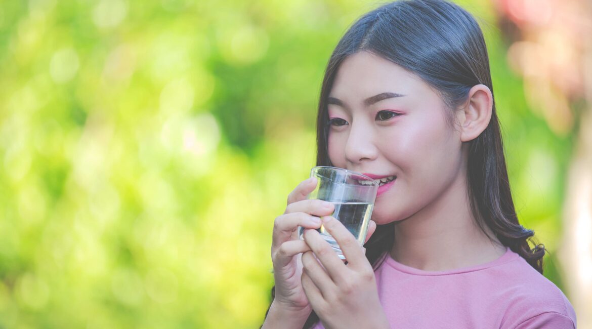 beautiful woman drink clean water from glass water