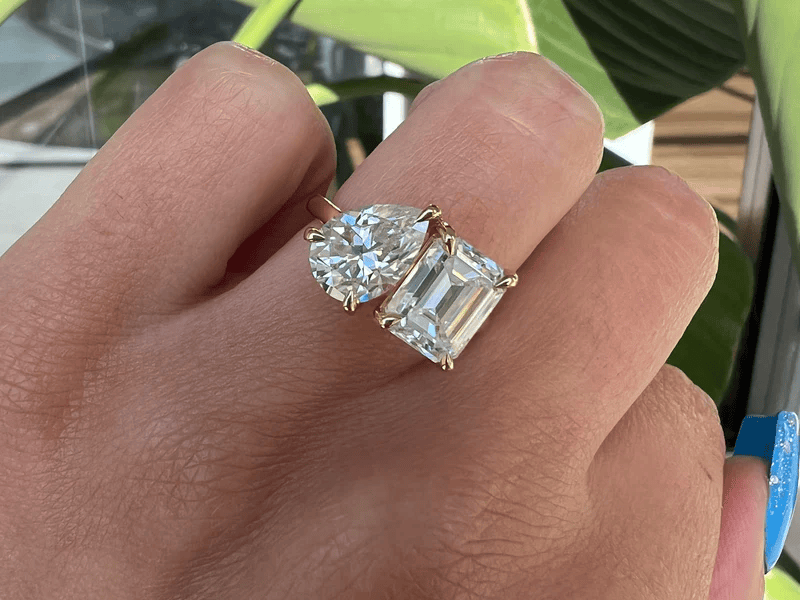 Moi et Toi engagement rings in yellow gold featuring round and emerald-cut gemstones, symbolizing love and unity by KRK Jewels.