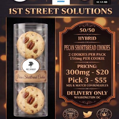 A sleek, vacuum-sealed clear tube containing two large, artisanal pecan-topped cookies from 1st Street Solutions, the premium choice for DC weed delivery.