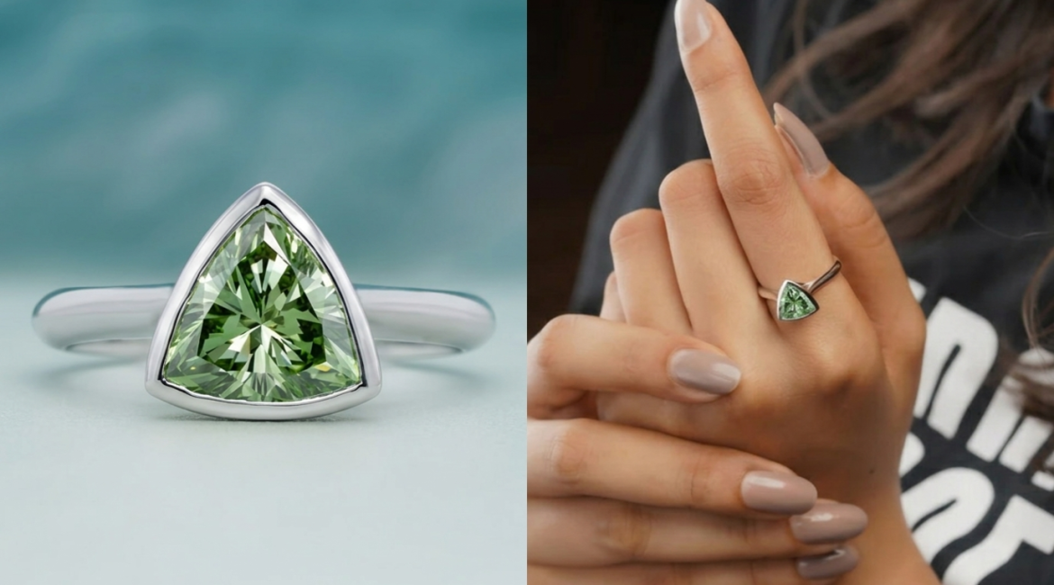 Trillion cut green diamond ring set in white gold, shown in a close-up product view and worn on a finger for a modern jewelry look.