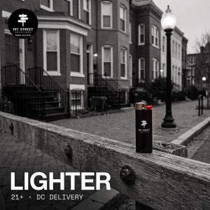 1st Street lighter on a weathered wooden rail on a black-and-white DC rowhouse street